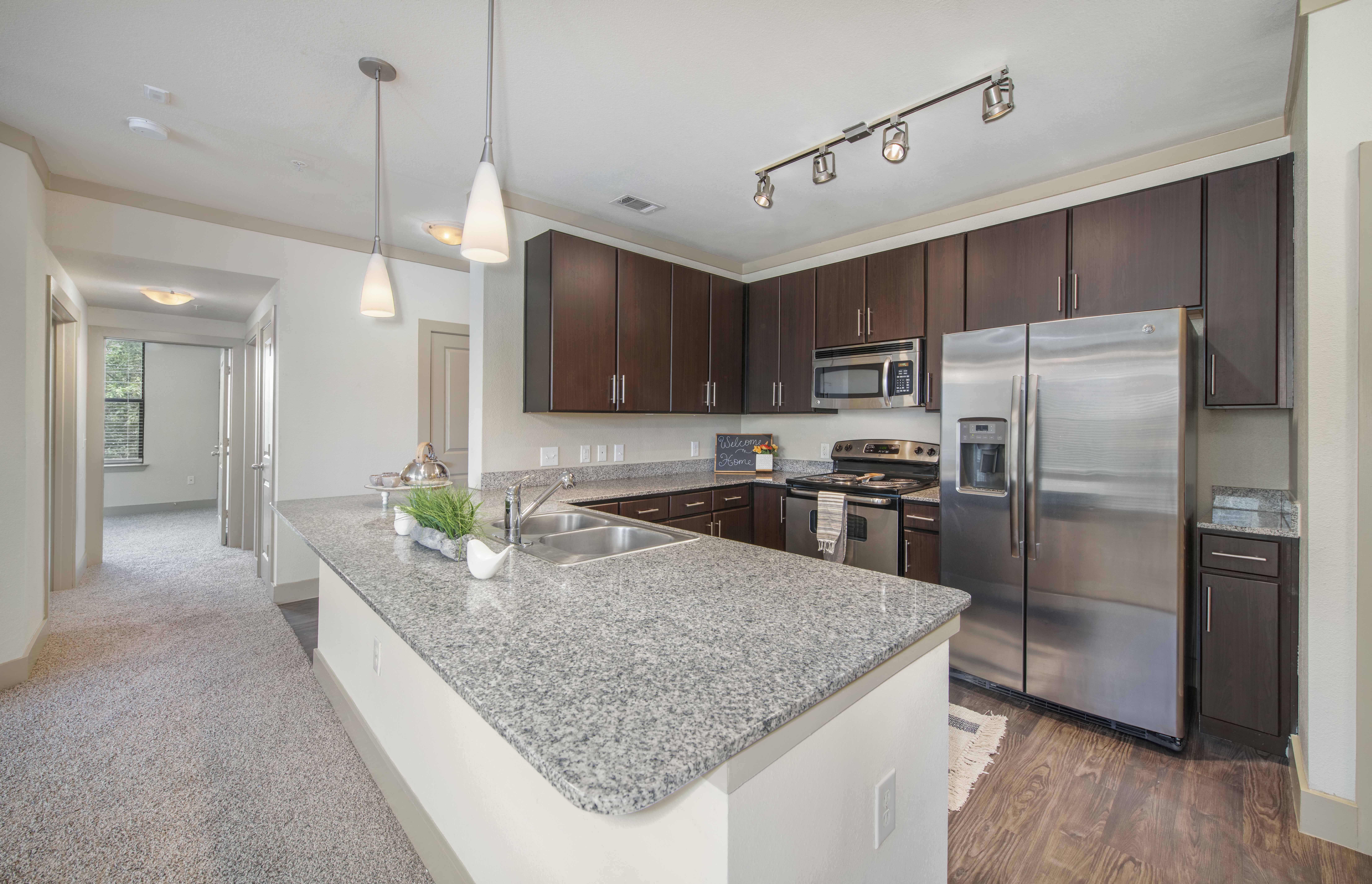 a kitchen with stainless steel appliances and granite counter tops