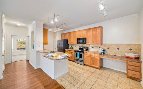 a large kitchen with wooden cabinets and a counter top