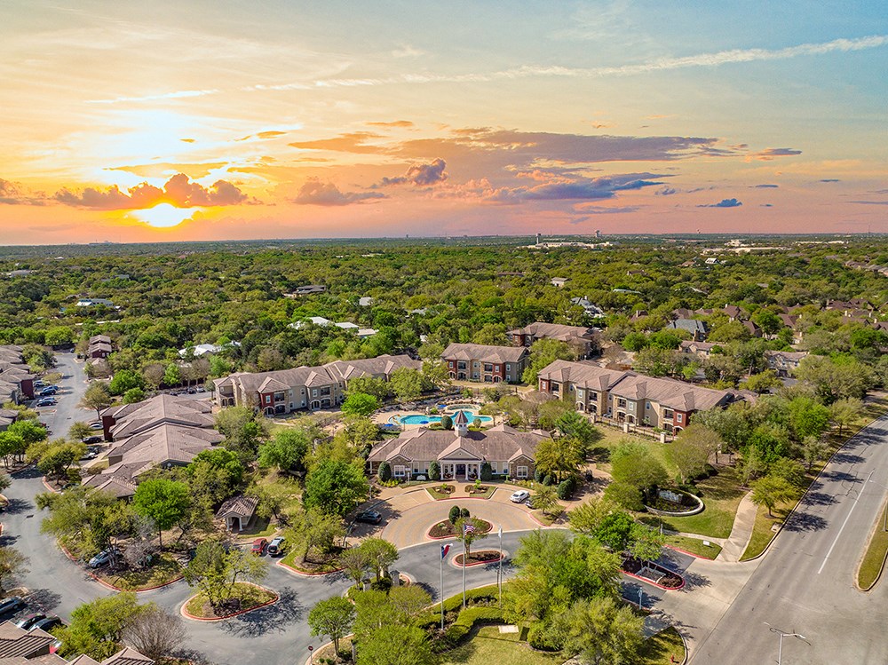 an aerial view of a neighborhood of houses at sunset