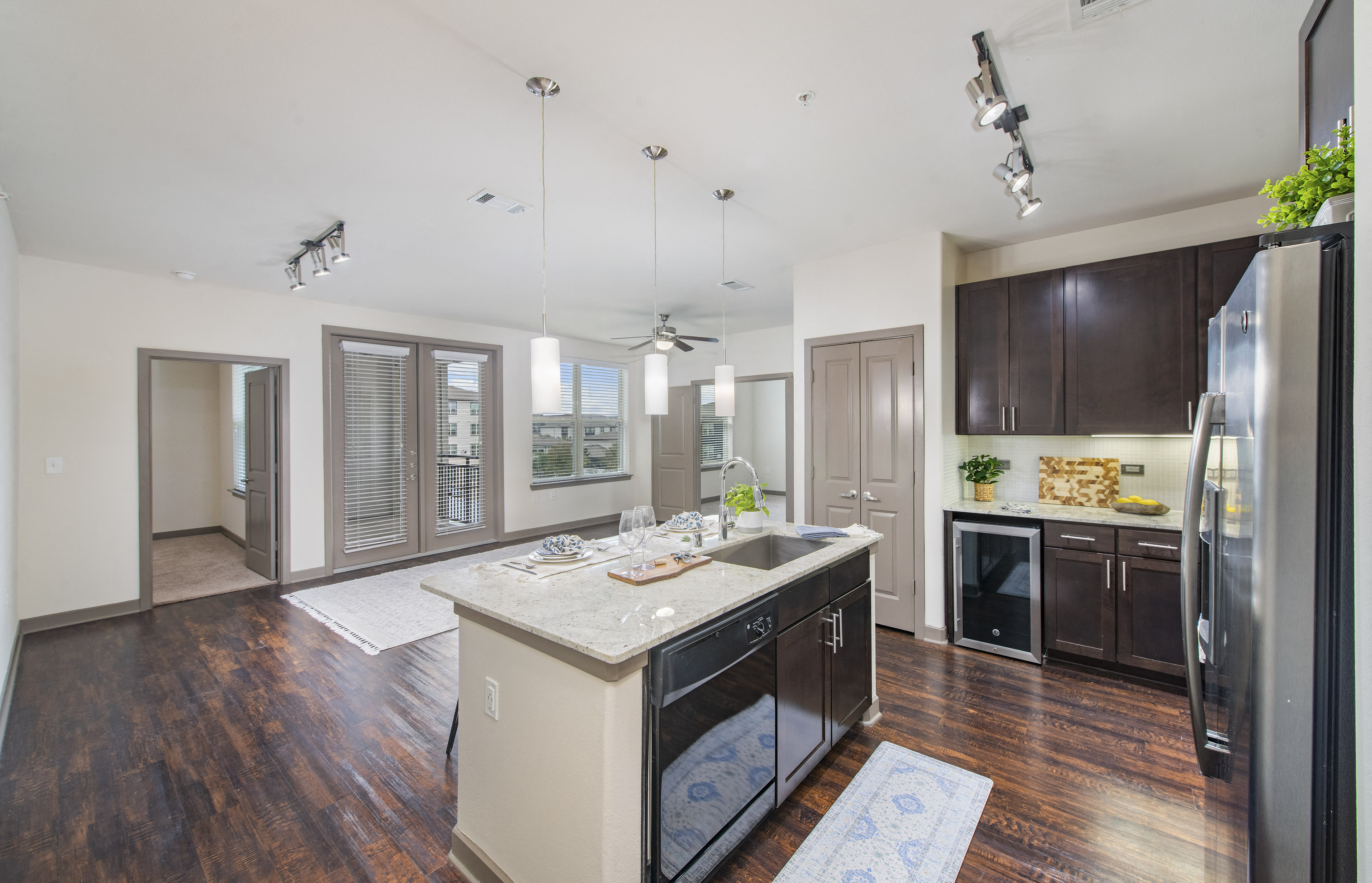 a kitchen with a center island and a stainless steel refrigerator