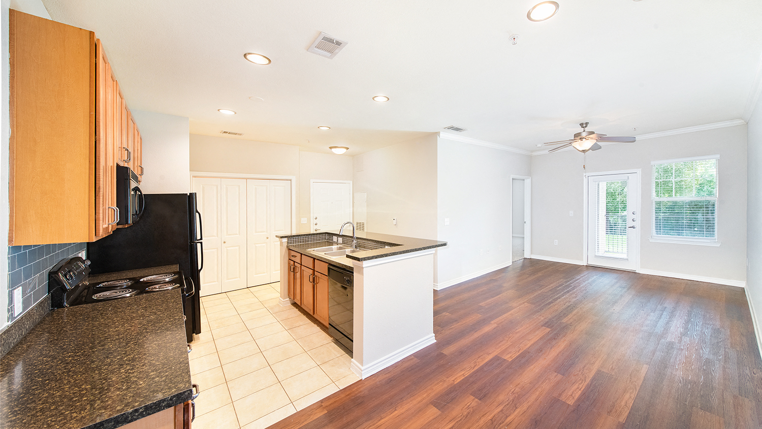an empty kitchen with a stove and a counter top