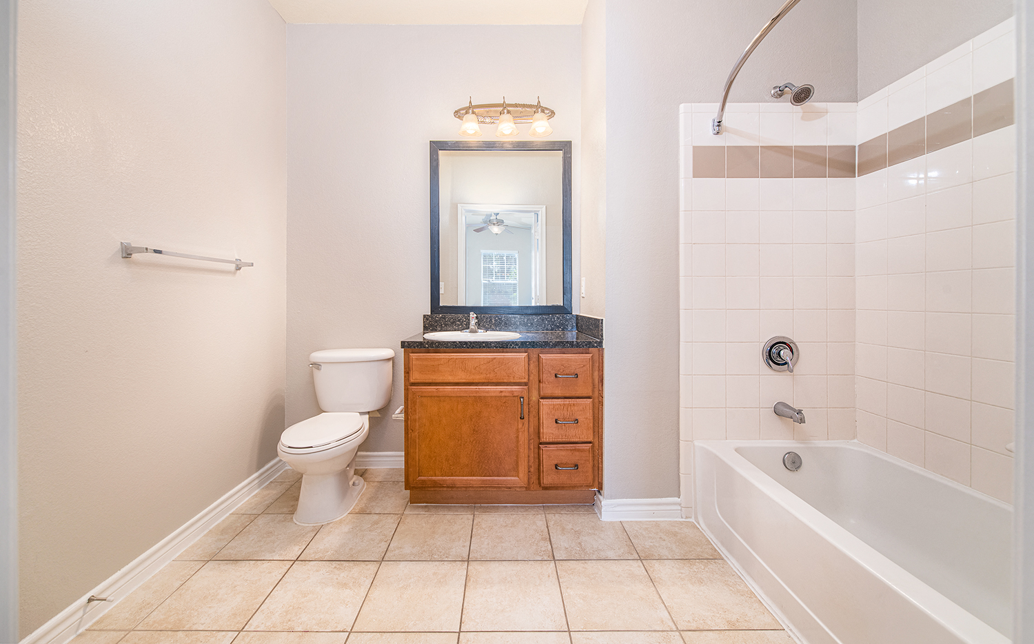 a bathroom with a toilet and a tub and a sink