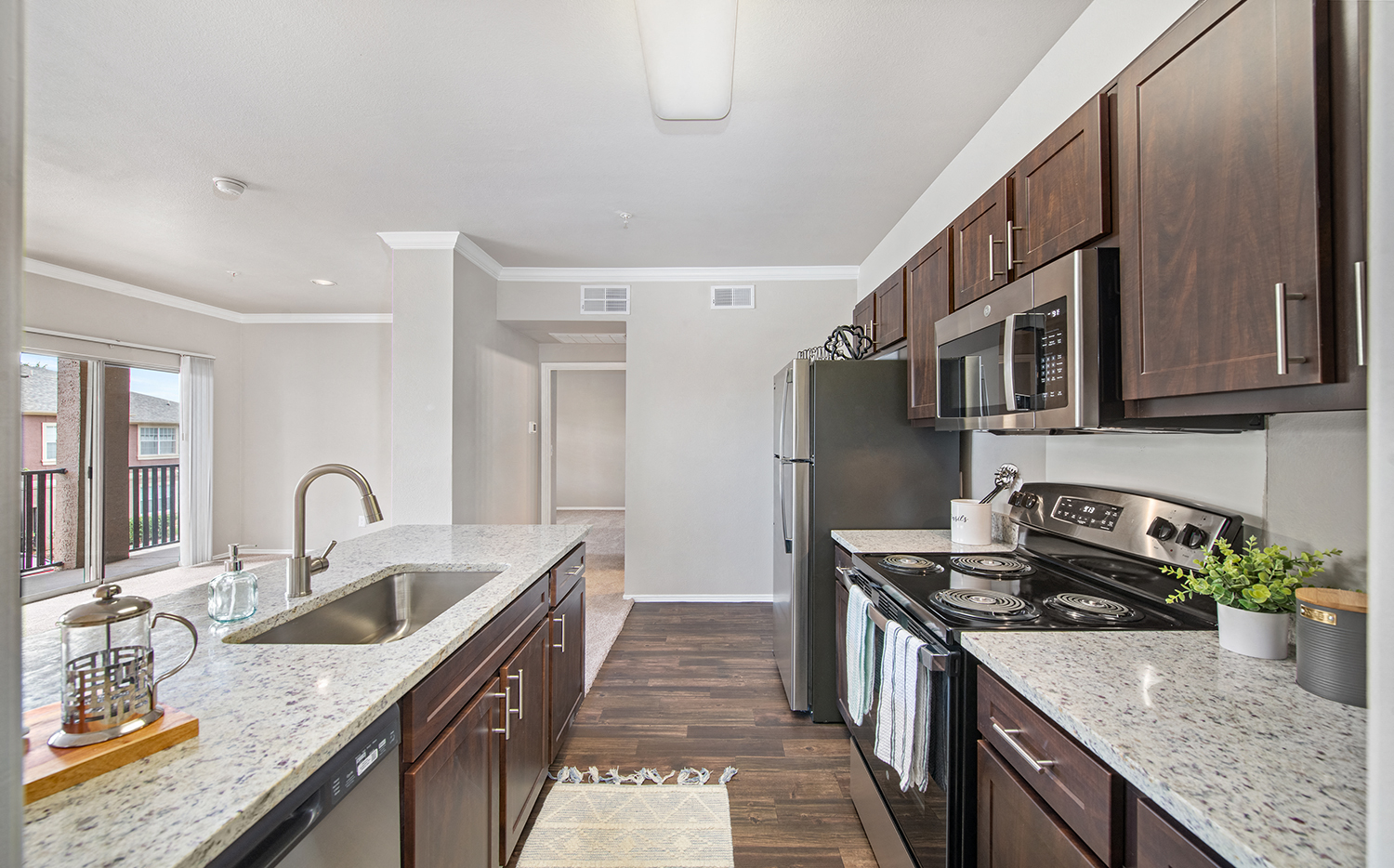 a kitchen with granite counter tops and stainless steel appliances