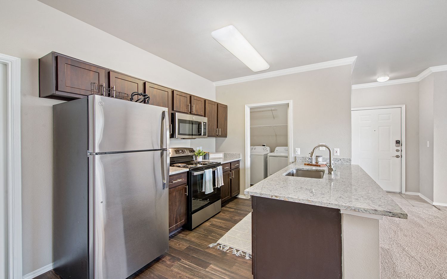 a kitchen with stainless steel appliances and a marble counter top