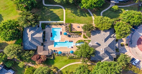a birds eye view of a house with a pool and a yard