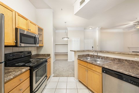 A kitchen with a black stove top oven and a black microwave.