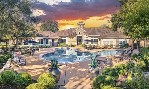 A large building with a pool in front of it.