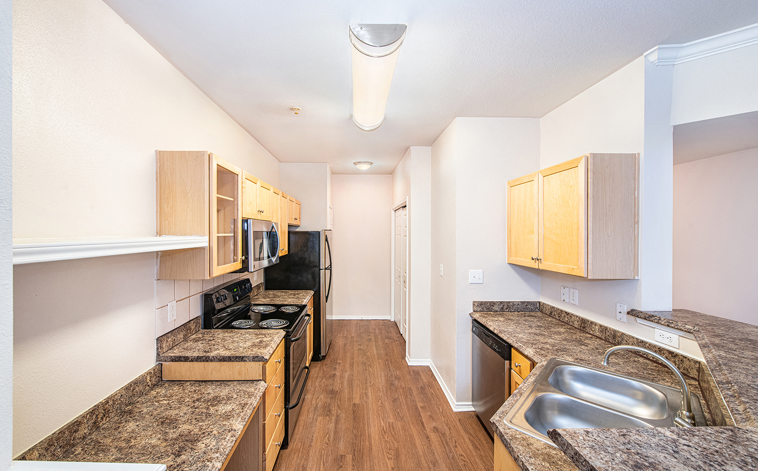 a kitchen with wood flooring and granite counter tops and