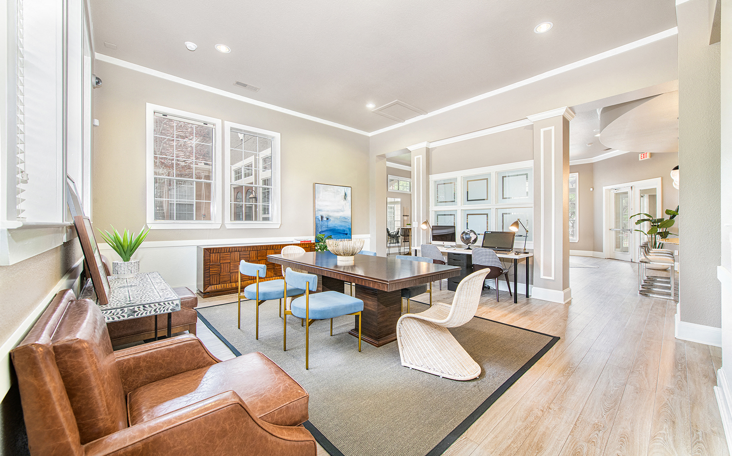 a living room with a dining room table and chairs