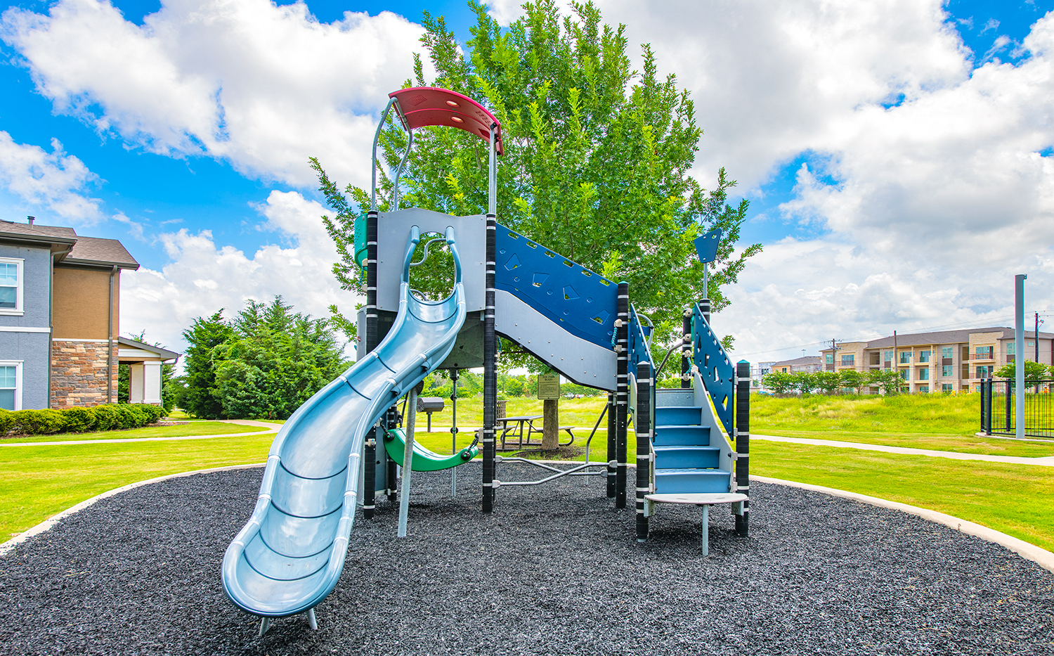 a playground with a slide on a sunny day