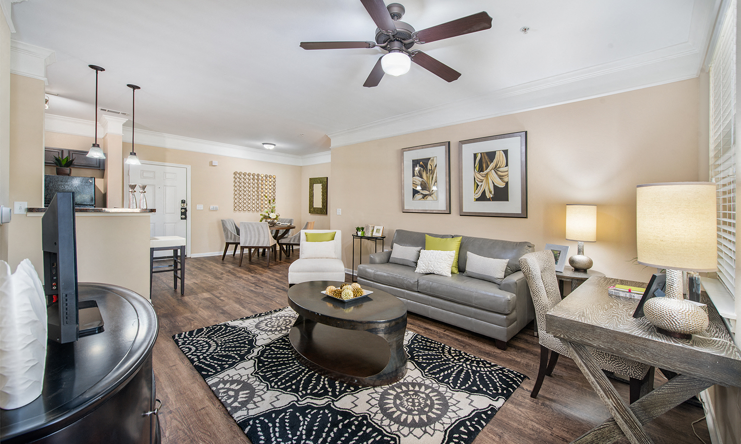a living room with a couch and a ceiling fan