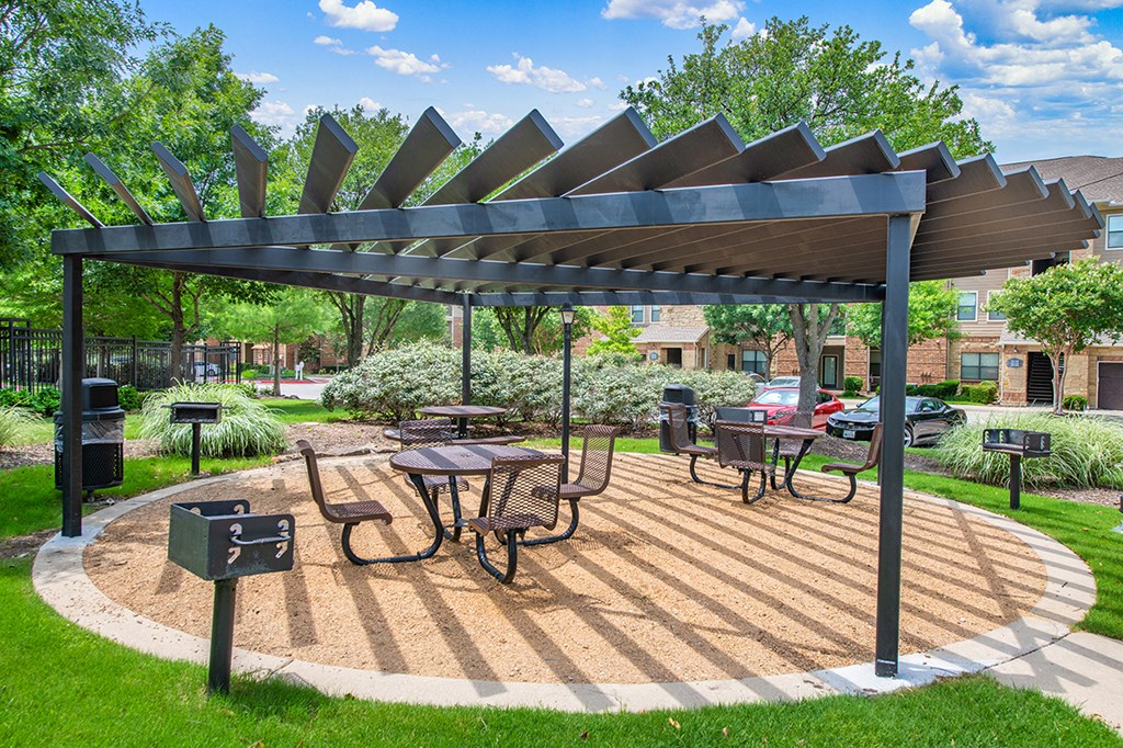 a patio with a table and chairs under awning