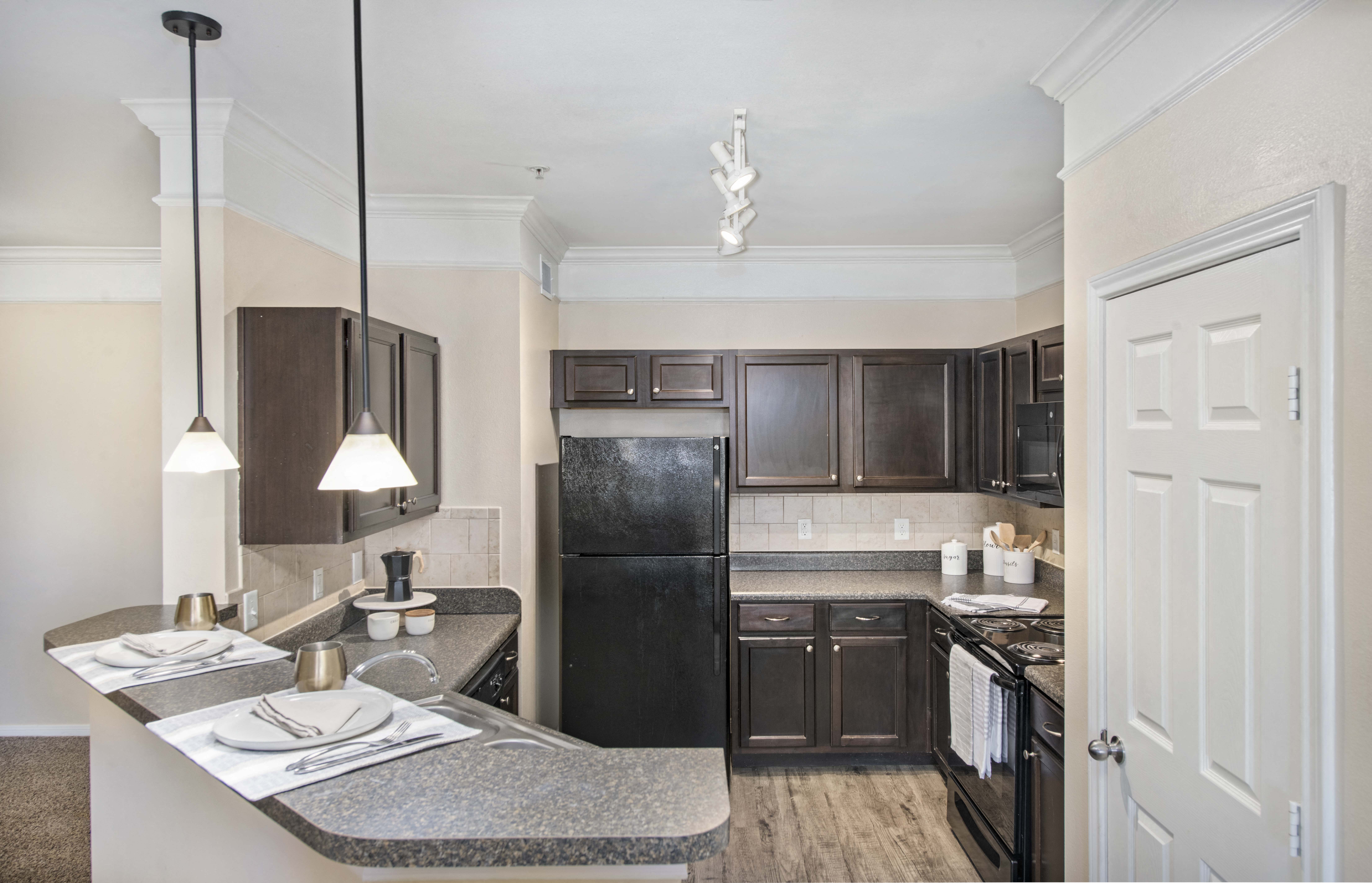 a kitchen with black appliances and granite counter tops