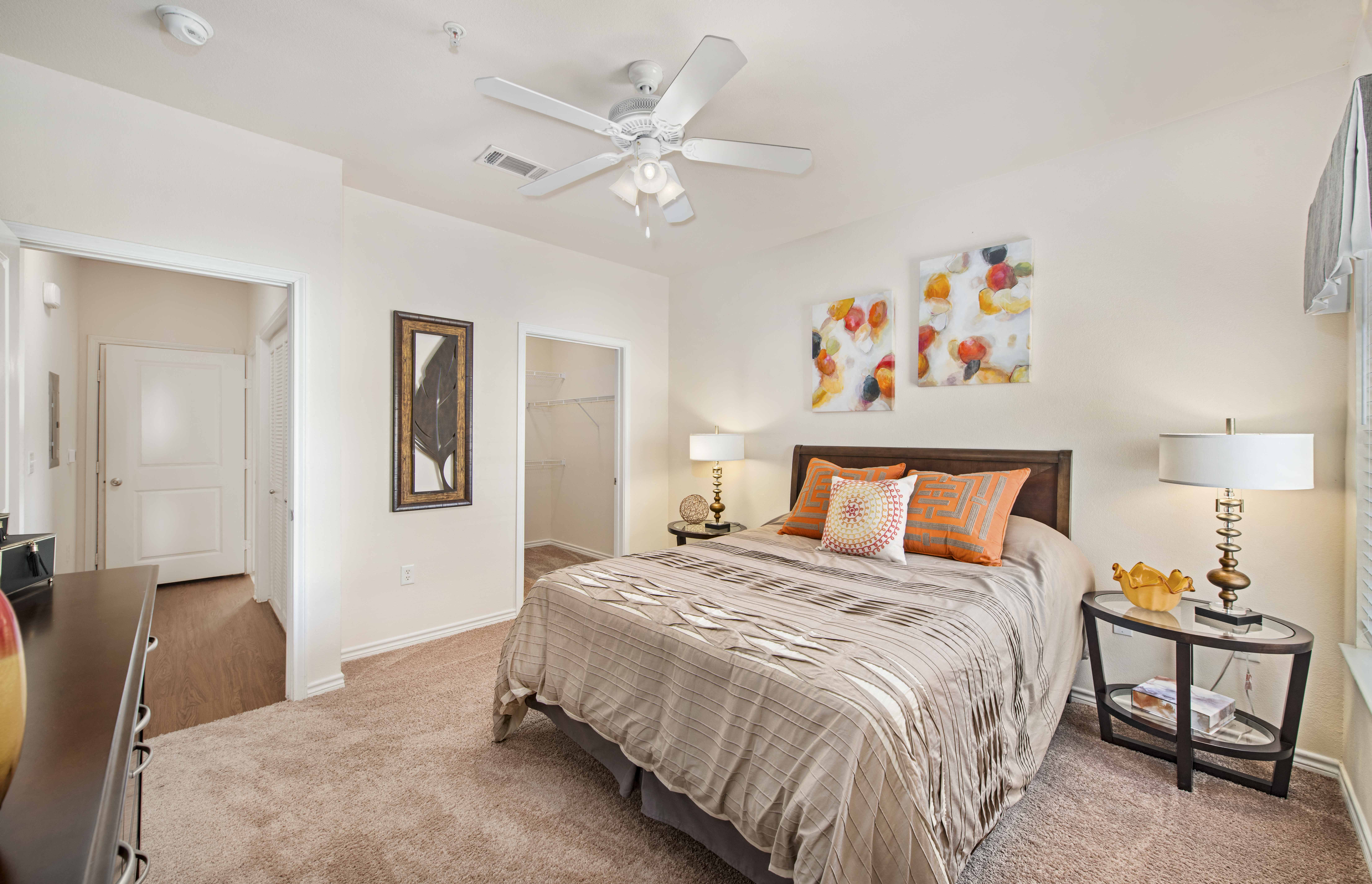 a bedroom with a bed and a ceiling fan