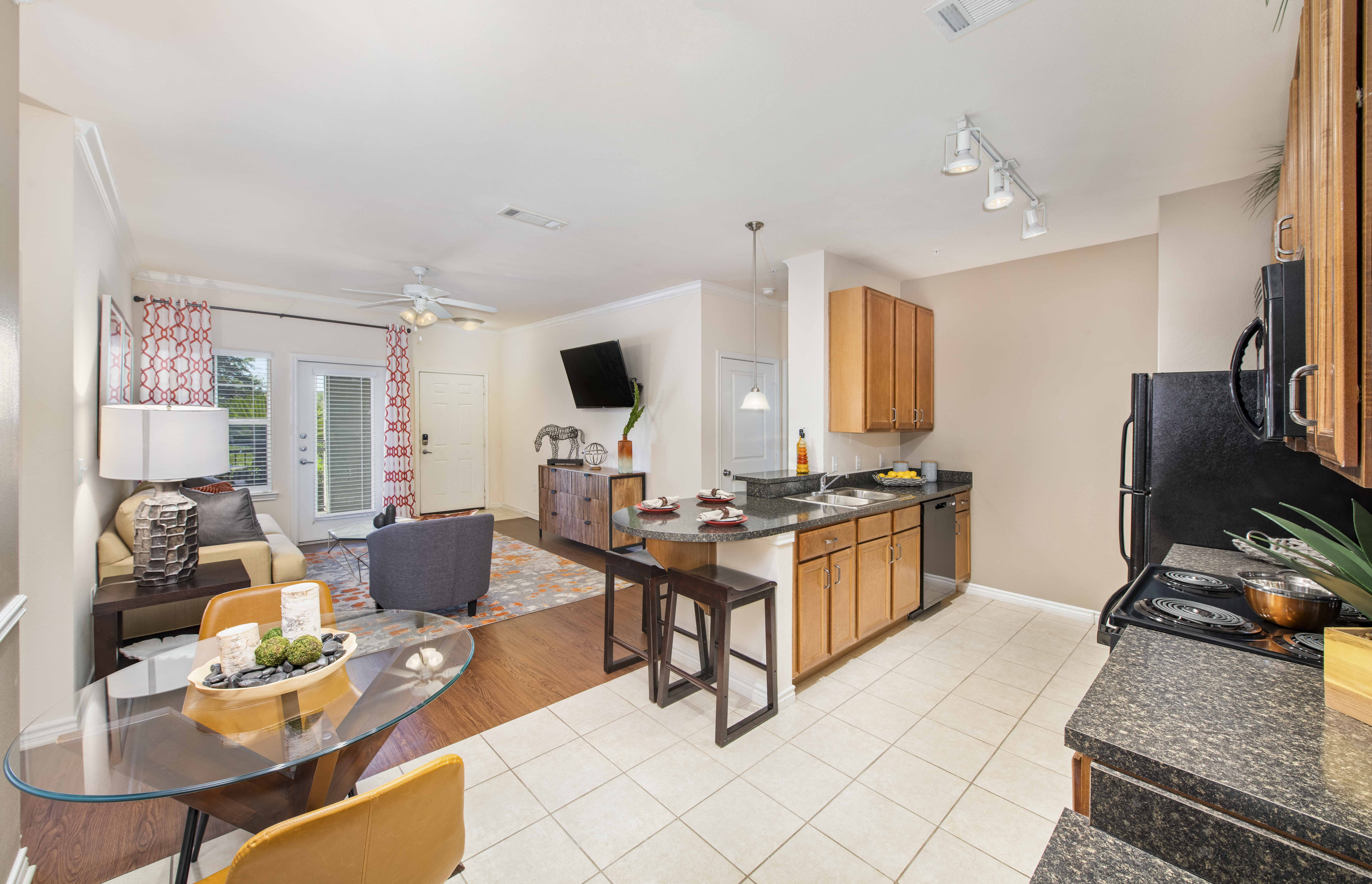 a living room with a kitchen and a dining room