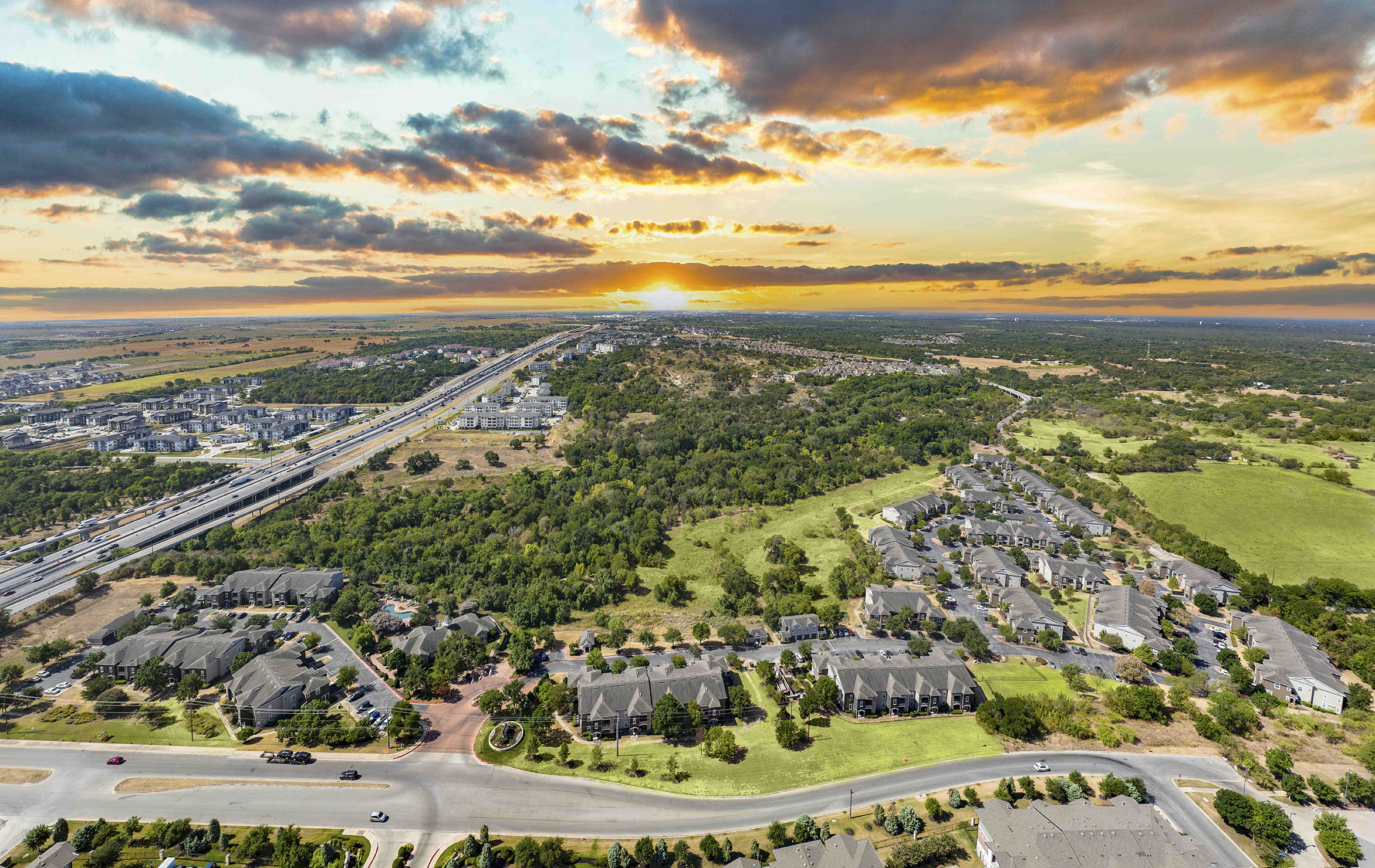 an aerial view of a city at sunset