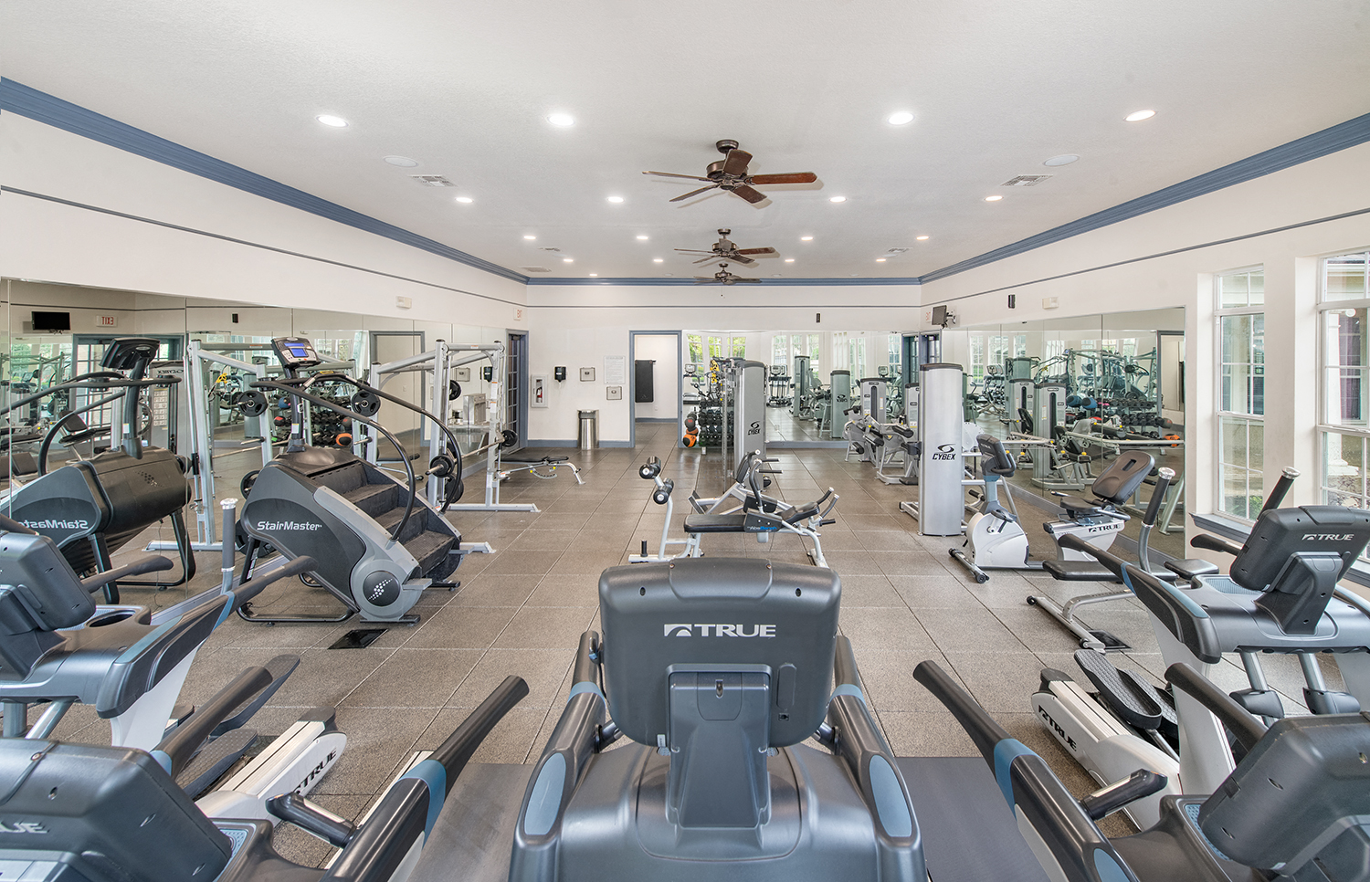 a gym with cardio machines and other exercise equipment