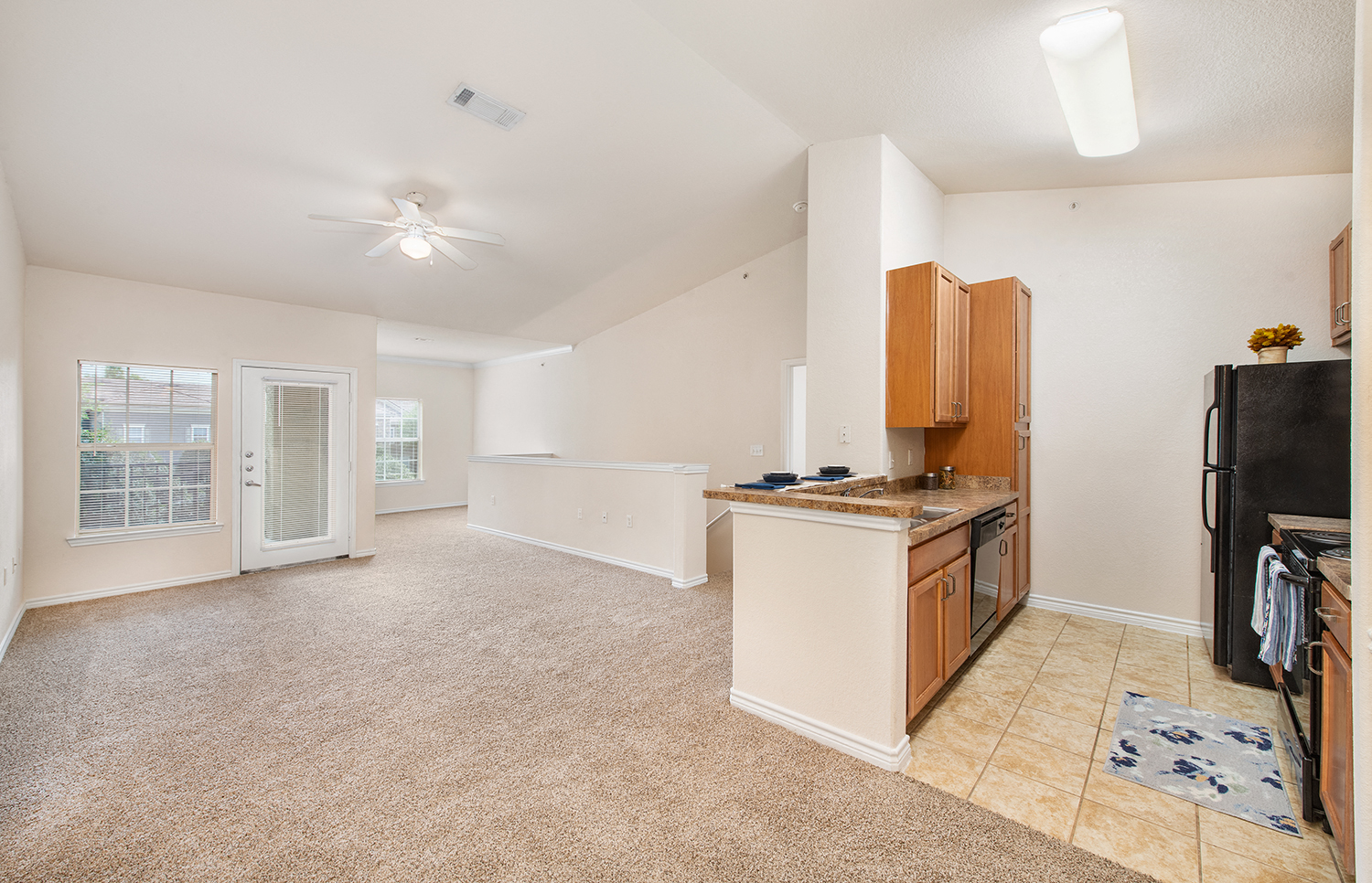 a kitchen and living room with an open floor plan