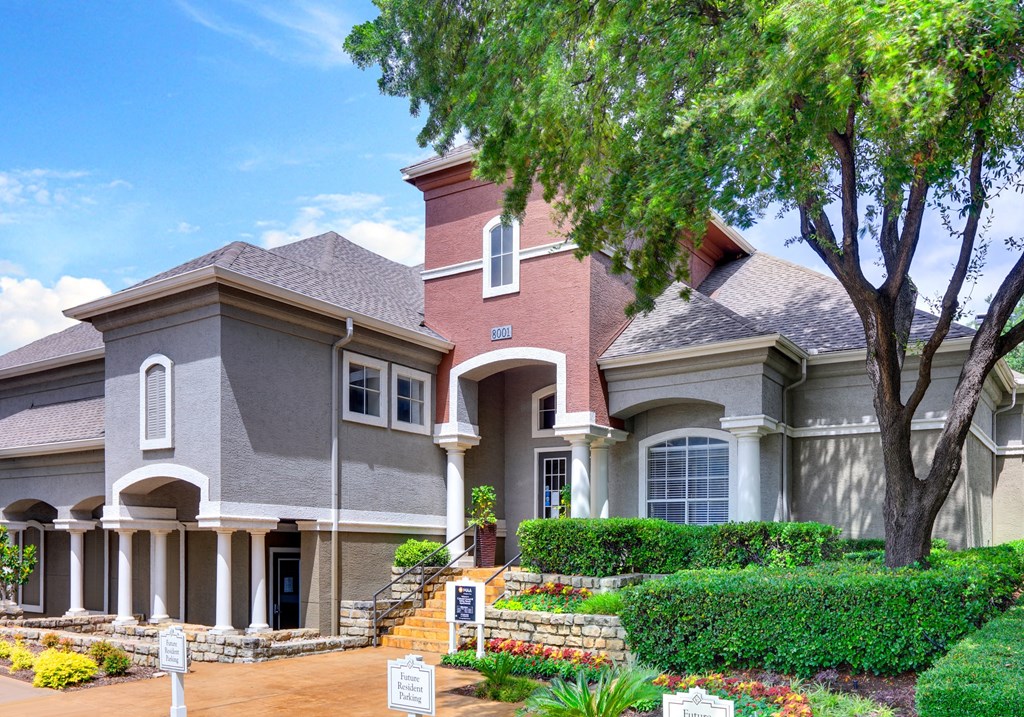 a large house with a tree in front of it