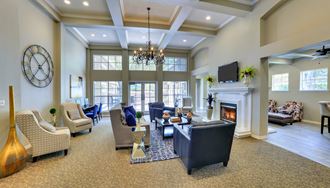 a large living room with furniture and a fireplace