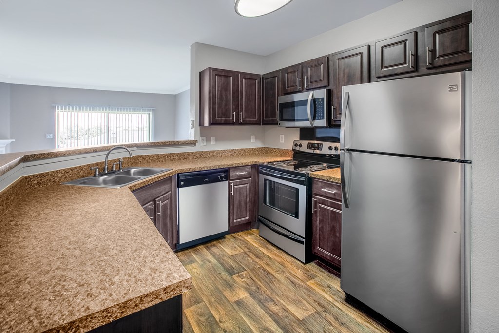 a kitchen with stainless steel appliances and granite counter tops