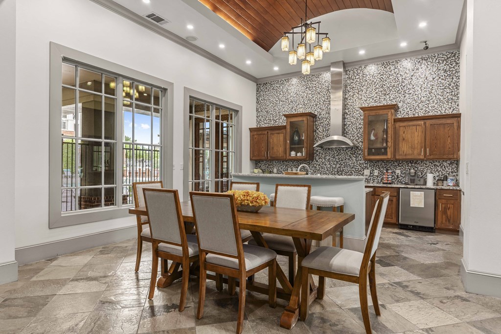 a dining room with a wooden table and chairs