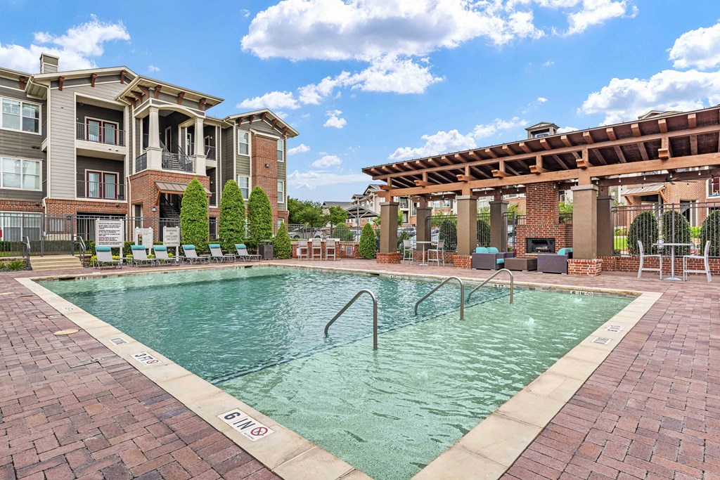 a swimming pool with a building in the background