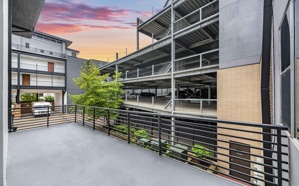 the balcony of a building with a sunset in the background