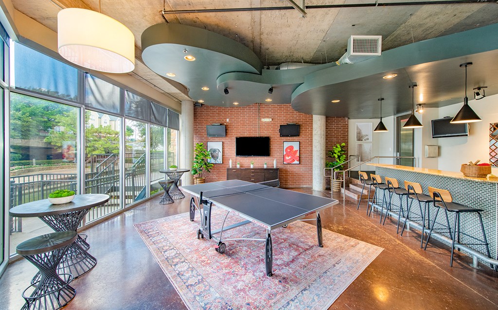 a ping pong table in the lobby of a building with glass doors