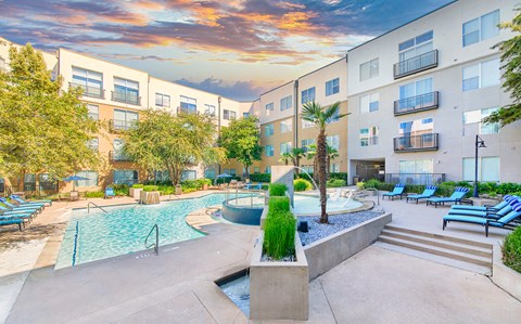 a courtyard with a pool and an apartment building