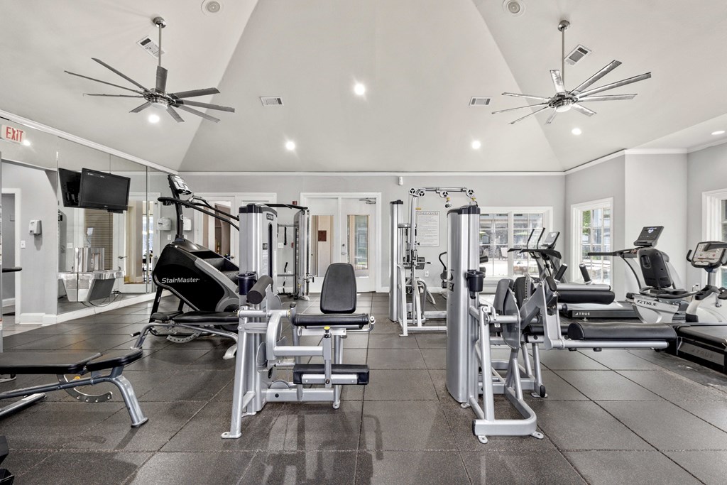 a gym with treadmills and other exercise equipment