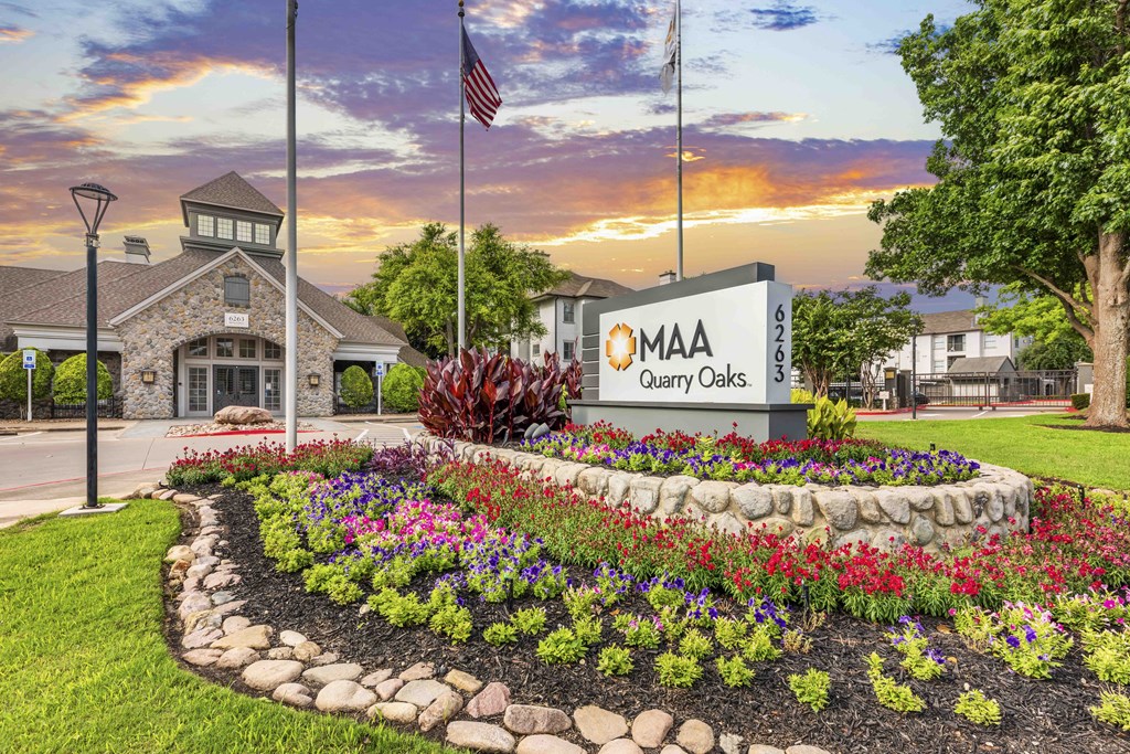 an exterior view quarry cares sign in front of a building with flowers