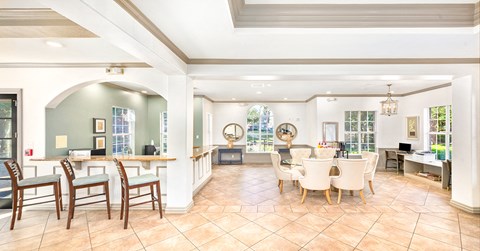 A spacious kitchen and dining area with a tiled floor and white walls.