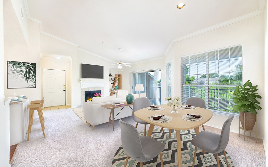 a living room and dining room with a table and chairs