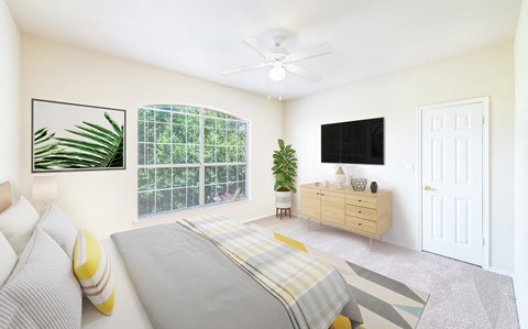 a bedroom with a bed and a ceiling fan