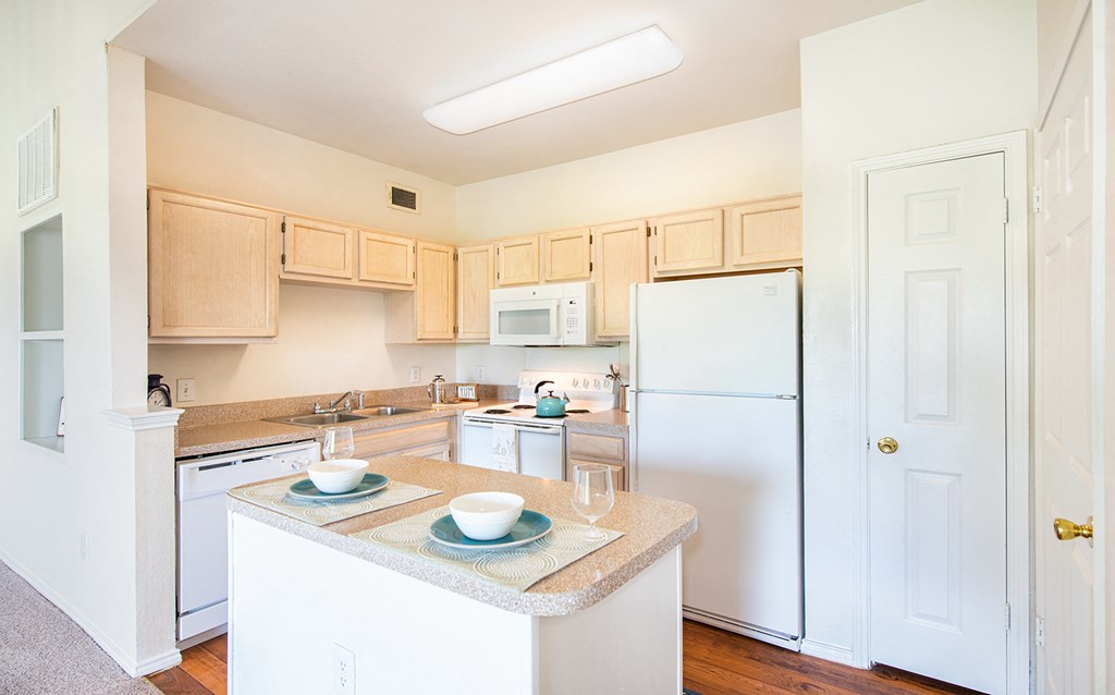 a kitchen with white appliances and a counter top