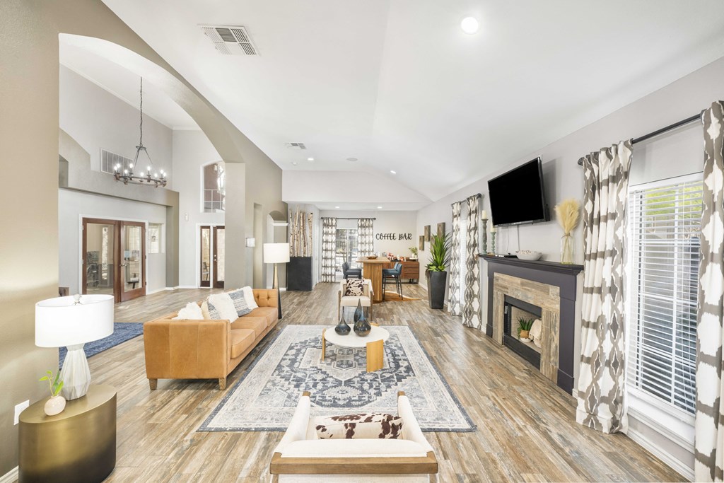 A living room with a fireplace and a TV mounted on the wall.