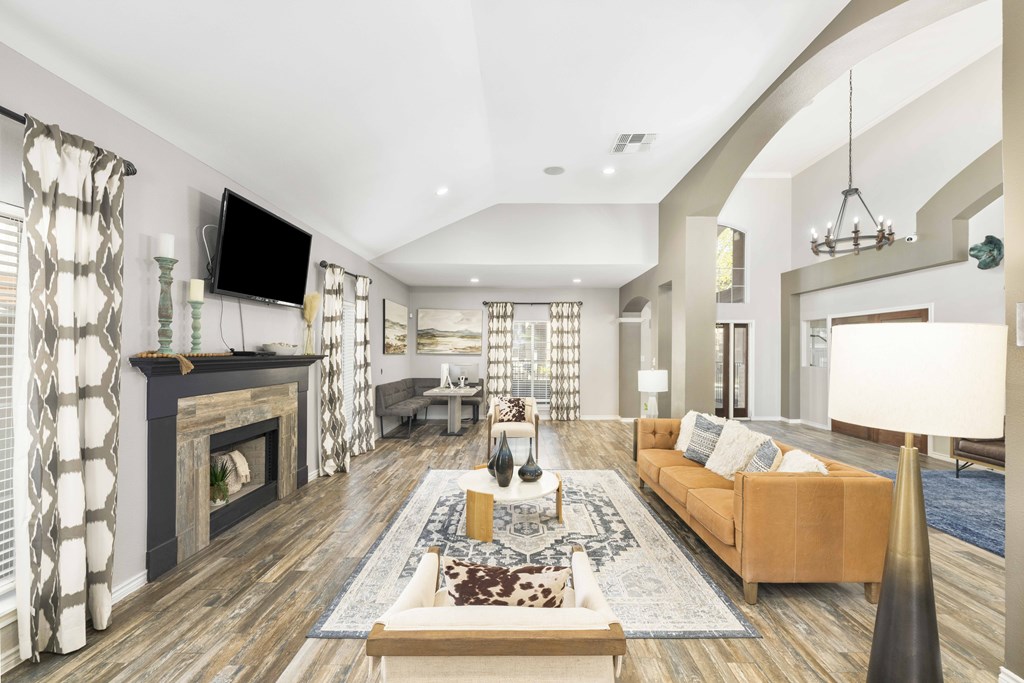 A modern living room with a fireplace and a television.