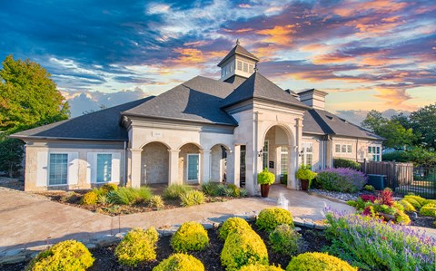 the front of a house with a sunset in the background