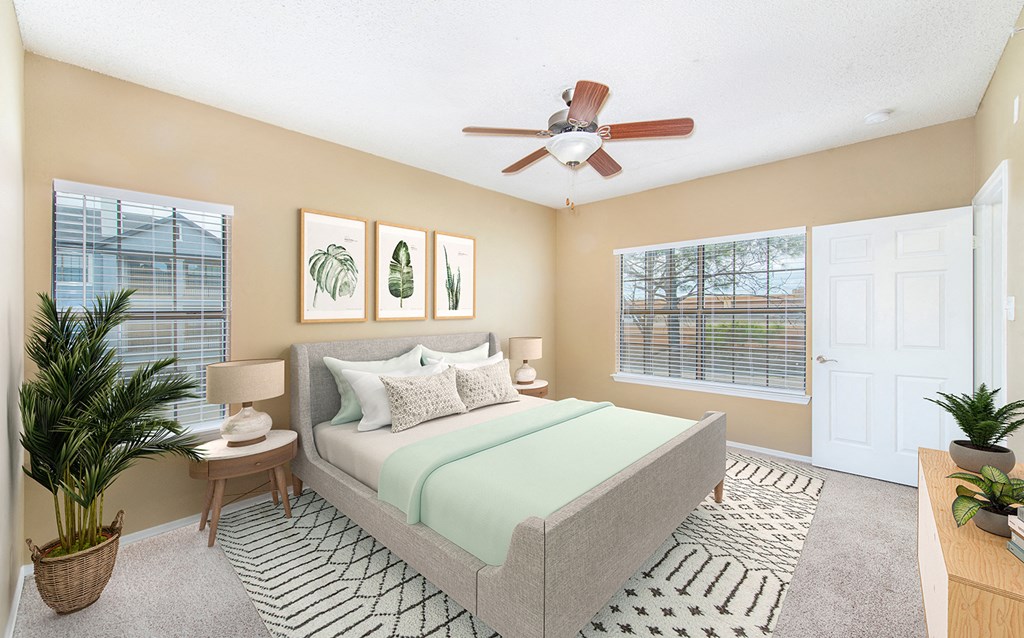 a bedroom with a ceiling fan and a bed