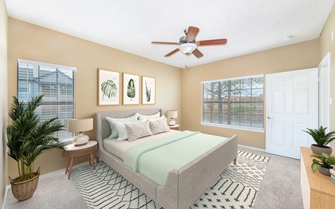 a bedroom with a ceiling fan and a bed