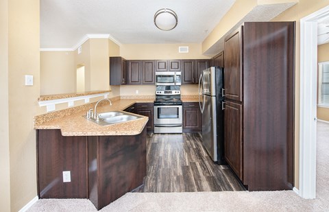 a kitchen with stainless steel appliances and wooden cabinets