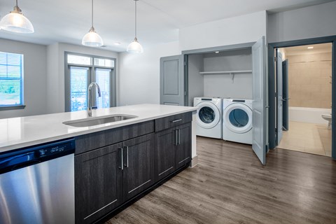 a kitchen with a washer and dryer and a laundry room