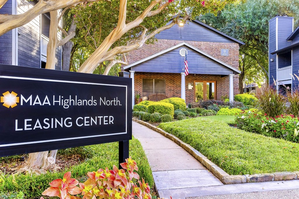 A sign for MAA Highlands North Leasing Center in front of a house.