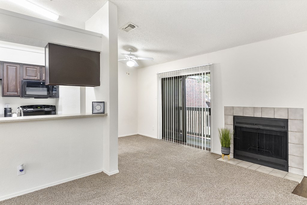 A living room with a fireplace and a flat screen TV.