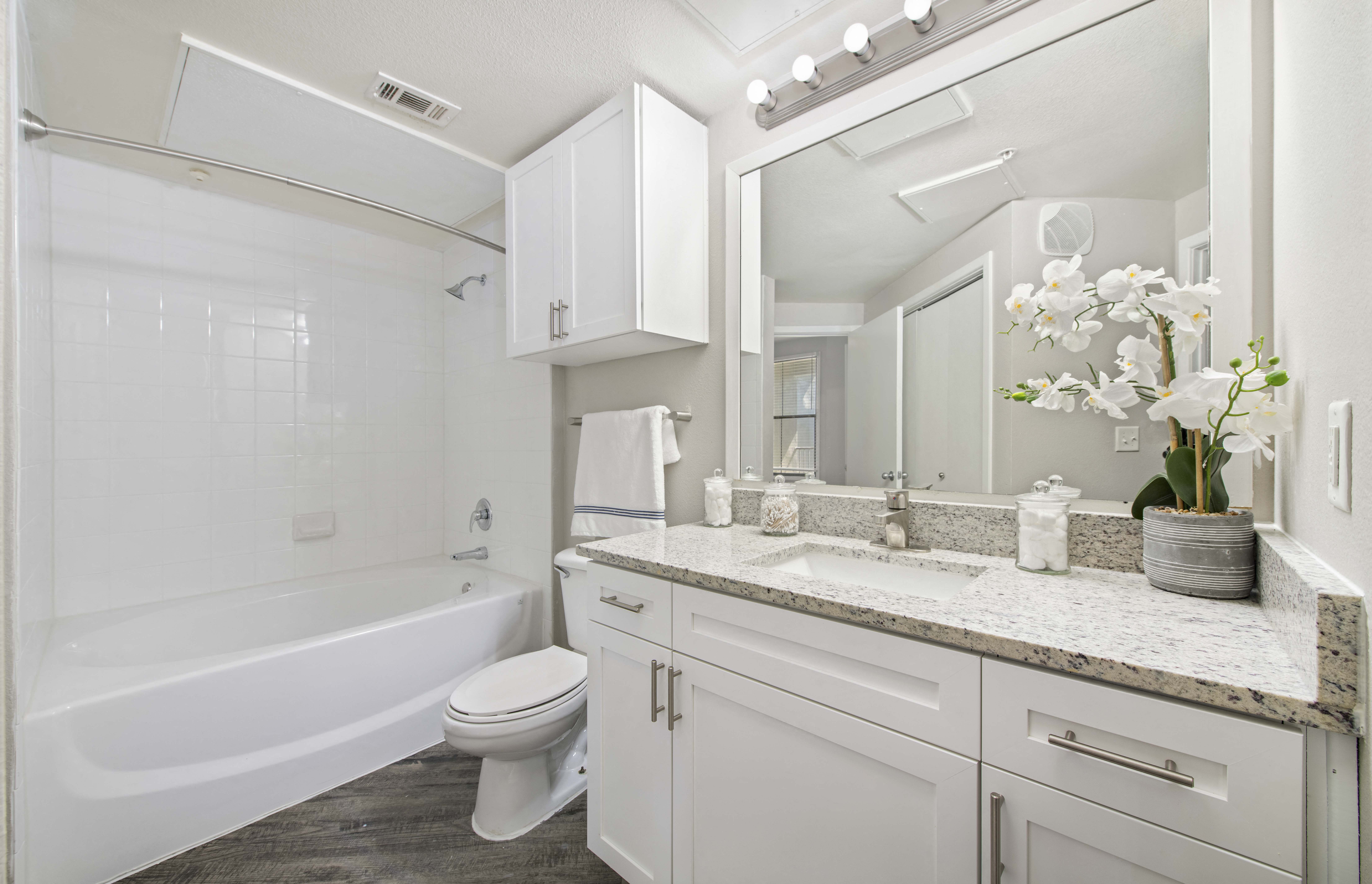 a white bathroom with a sink and a toilet