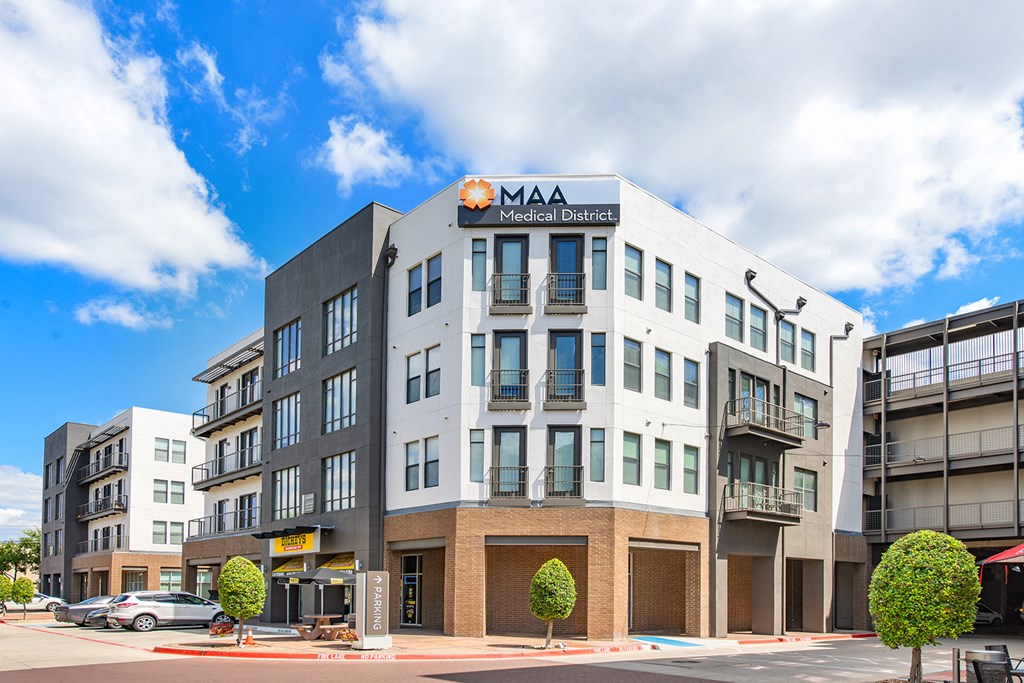 a large building with a sign on top of it on a street