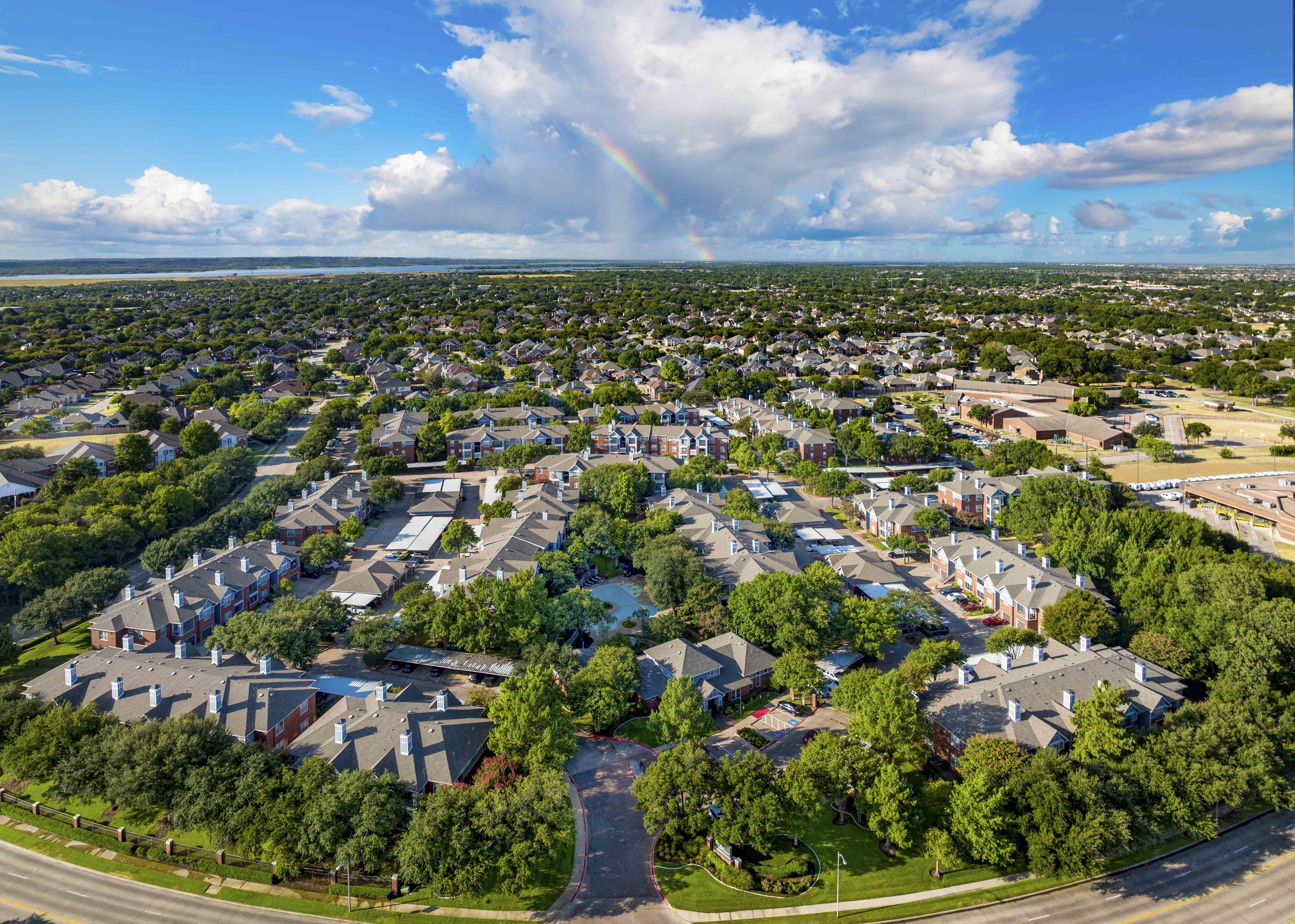 an aerial view of a neighborhood with houses and trees