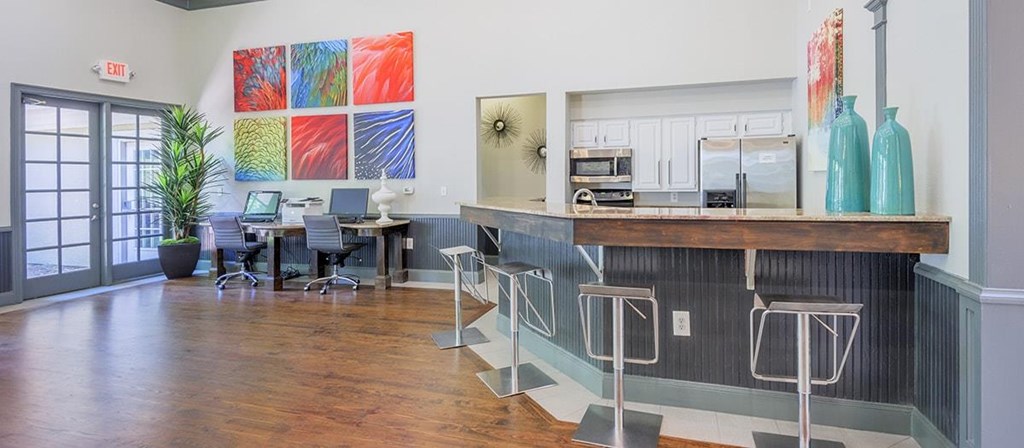 a room with a bar and a desk with chairs