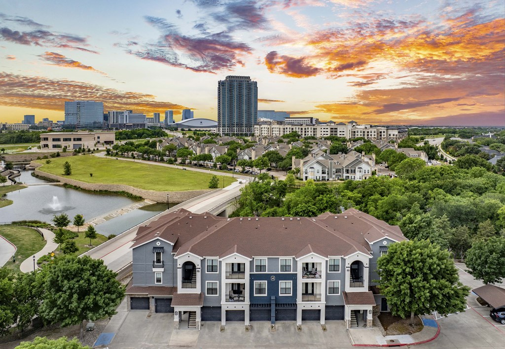 an aerial view of a house with a river and a city in the background